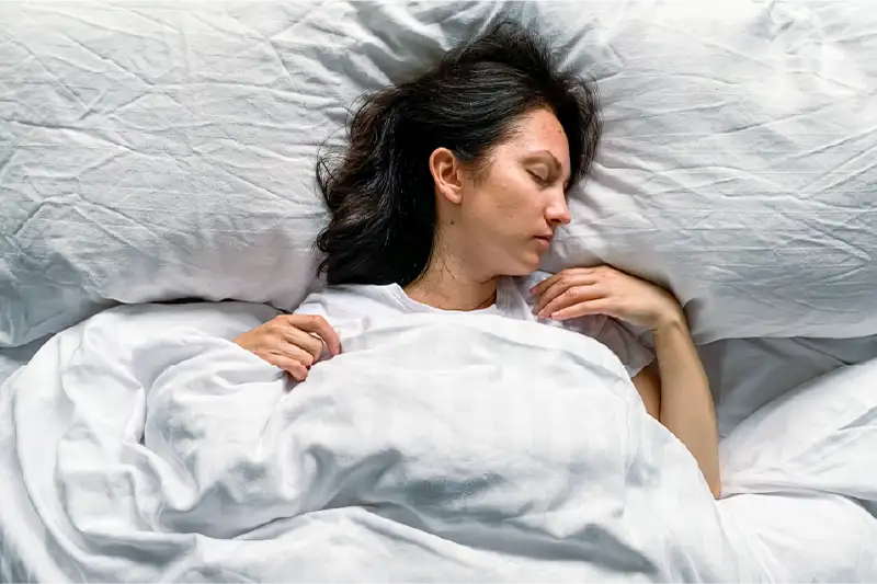 Augusta chronic pain patient adjusting sleep position for relief.